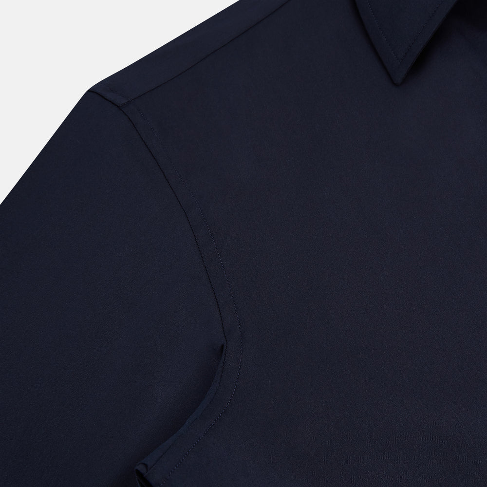 The Navy Westminster Shirt by Turnbull & Asser is a classic long-sleeve, button-up shirt with a pointed collar and buttoned cuffs, exemplifying British craftsmanship, shown against a plain white background.