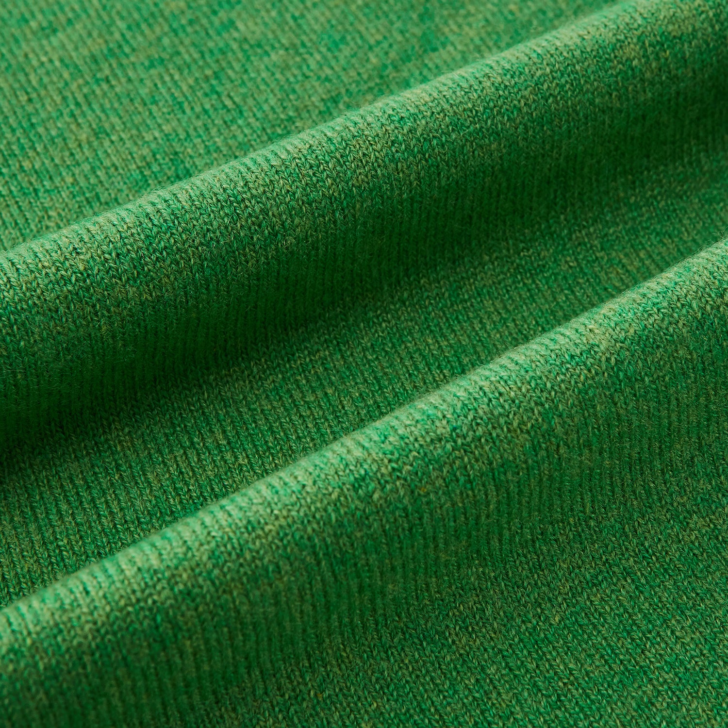 Image 3 of product The Turnbull & Asser Plain Kelly Green Cashmere Knitted Scarf is shown looped at the top with both ends hanging down, its soft texture and vibrant color standing out against a plain white background.