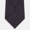 View 3 of product The Turnbull & Asser Magenta and Navy Square-Patterned Silk Tie is neatly rolled on a plain light background.
