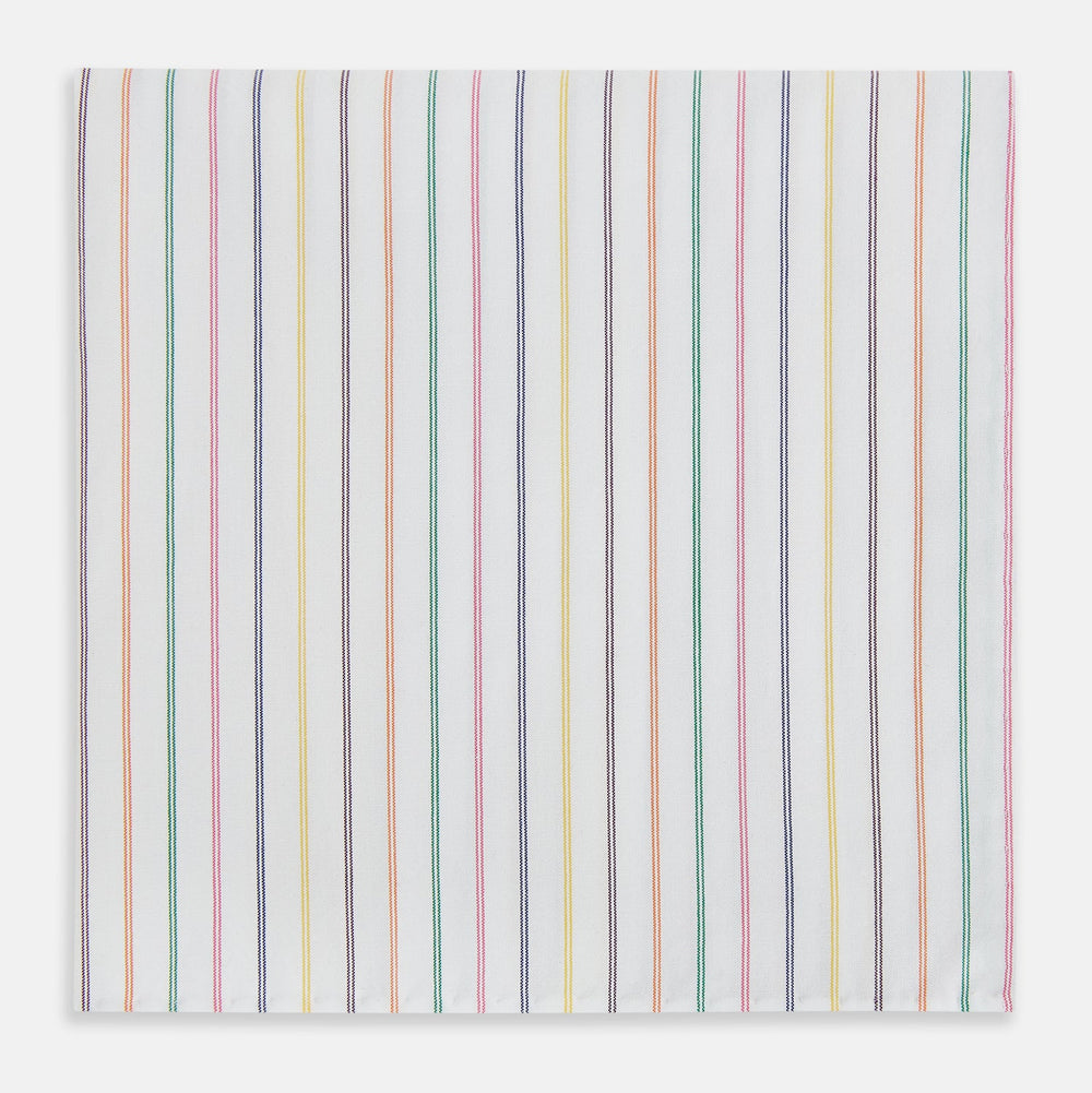 Turnbull & Asser’s Rainbow Double Pinstripe Hand-Rolled Handkerchief features a white square design with slim red, blue, green, and yellow stripes and refined hand-rolled edges.