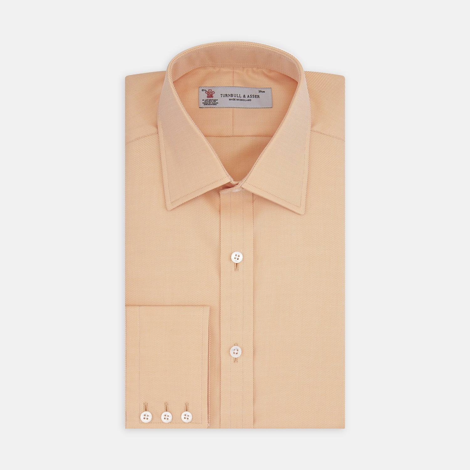 View 1 of product A neatly folded Orange Oxford Classic Fit Shirt with a T & A collar by Turnbull & Asser is displayed on a white background—a versatile piece for minimalist outfits or pairing with bold ties.