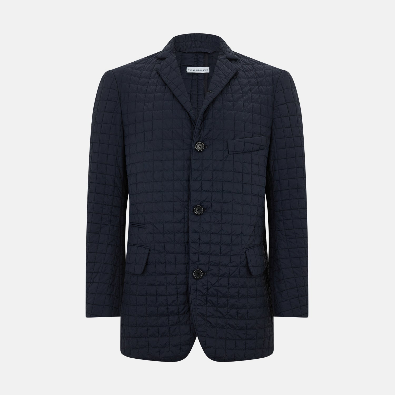 View 1 of product The Fulham Navy Single-Breasted Quilted Blazer by Turnbull & Asser features a notched lapel, three black buttons, a chest pocket, and two front flap pockets. Shown on a plain white background—ideal for the modern gentleman.
