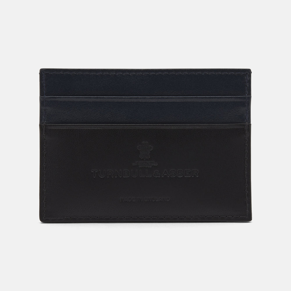 The BLACK LEATHER CARD HOLDER by Turnbull & Asser features multiple card slots and an embossed logo on front, crafted in minimalist black leather and showcased on a plain white background.