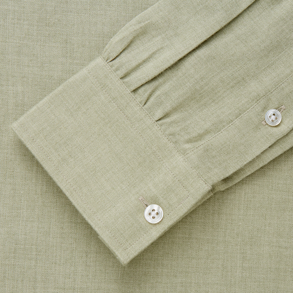 The Turnbull & Asser Soft Green Cashmerello Weekend Fit Finch Shirt features a Derby collar, long sleeves, chest pocket, white buttons, and cuffs. Laid flat on a white background.