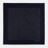 View 3 of product The Navy and Charcoal Stripe Silk Pocket Square by Turnbull & Asser features fine hand-rolled edges, thin white stripes on navy, and TURNBULL & ASSER HAND PRINTED IN ENGLAND in white on the corner.
