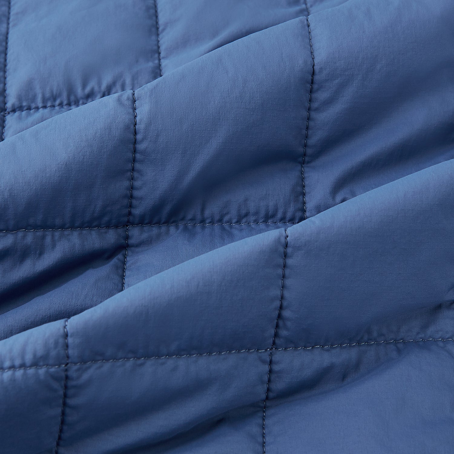 View 4 of product The Azzurro Quilted Gilet by Turnbull & Asser is a sleeveless, lightweight men’s outerwear piece featuring a front zipper, angled zippered pockets, and a chest pocket, shown against a plain white background.