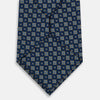 View 3 of product The Turnbull & Asser Navy Diamond Silk Tie features a diamond pattern of small white and yellow squares, embodying British craftsmanship, shown on a plain white background.