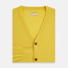 View 4 of product The Turnbull & Asser Canary Yellow Fine Merino V-Neck Cardigan features long sleeves, a button front with brown buttons, and ribbed cuffs and hem, displayed on a plain white background.