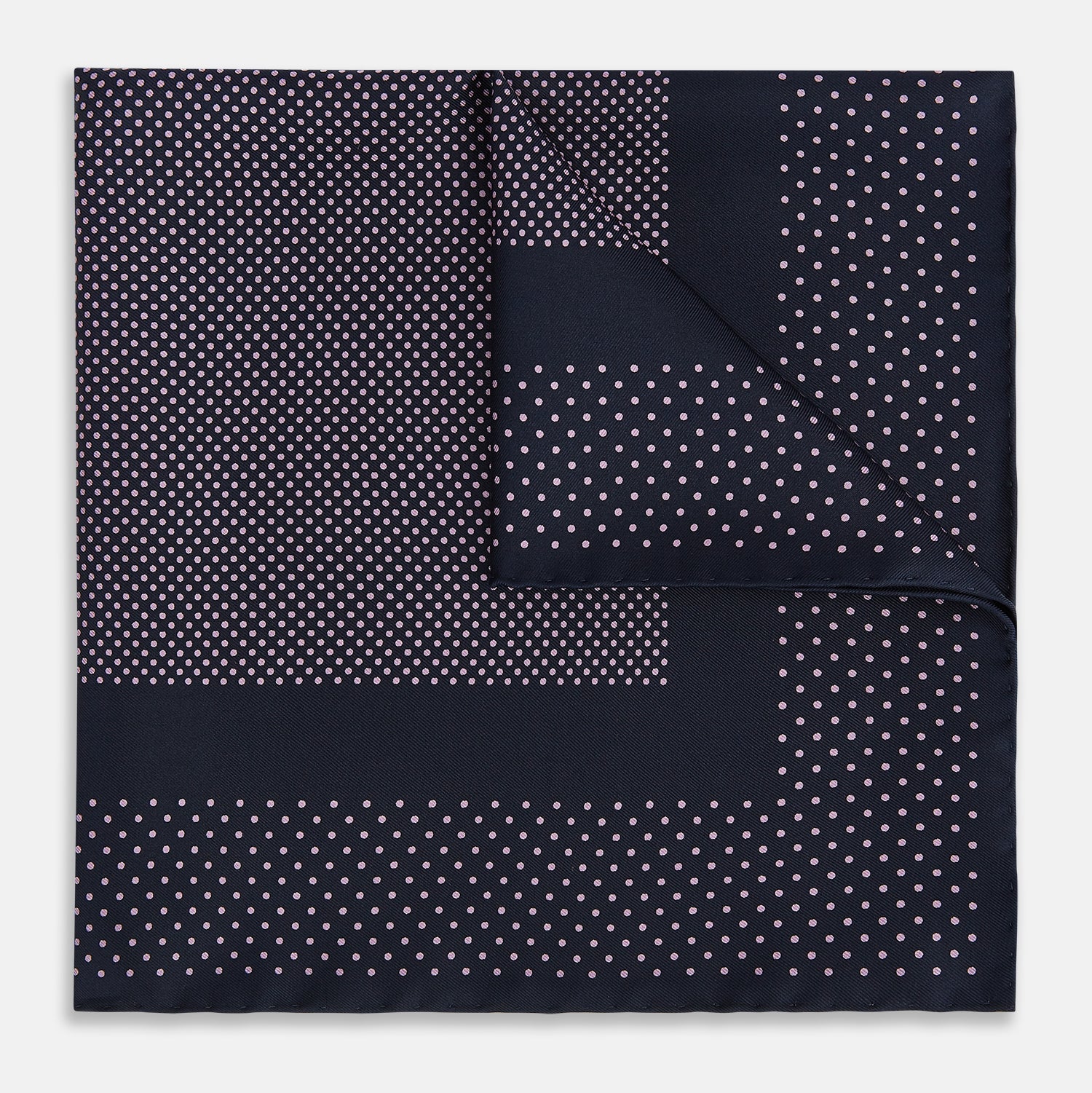 View 1 of product The Turnbull & Asser Navy and Lilac Dot Silk Pocket Square features small white polka dots with a wider border of spaced-out dots, neatly folded to showcase both sides of its handmade silk fabric.