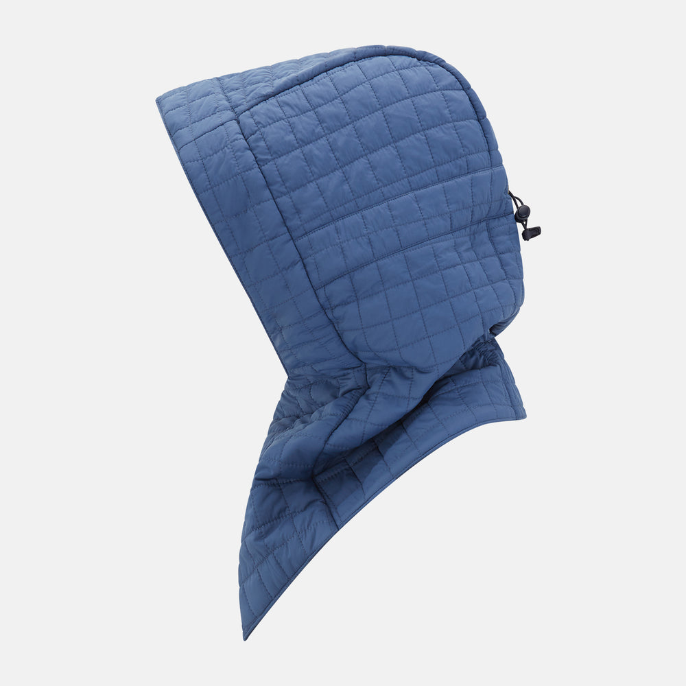 The Turnbull & Asser Azzurro Quilted Hood with Neck Warmer features a grid-stitched pattern, button closure, and overlapping front for added style. It draws inspiration from classic quilted jackets and is shown on a plain white background.