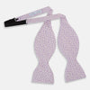 View 2 of product The Turnbull & Asser Lilac Flower Patterned Silk Bow Tie showcases small white flowers on lilac silk, making it a refined accessory for smart outfits. Shown against a white background.