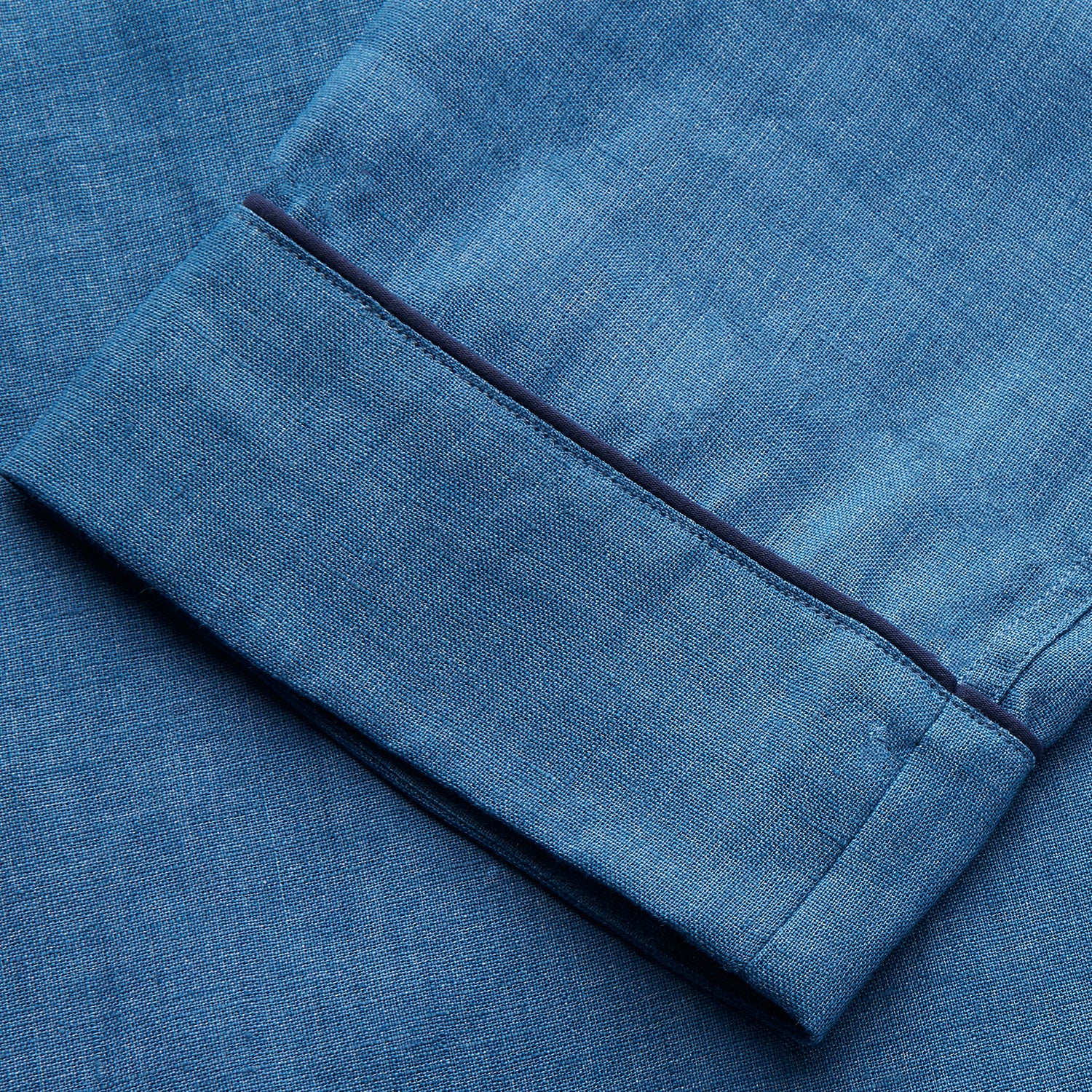 View 7 of product A person stands barefoot against a plain background, wearing the Teal Linen Modern Pyjama Set from Turnbull & Asser.