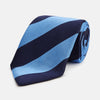 View 1 of product The BLOCK STRIPE NAVY RIVER TIE by Turnbull & Asser features bold navy and light blue diagonal stripes, rolled up neatly on a white background—a stylish essential for elevating any formal look.