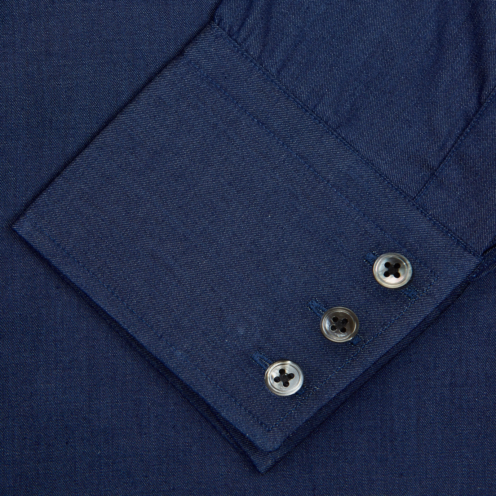 View 5 of product The Turnbull & Asser Dark Blue Denim-Cashmere Shirt features a Regent collar, long sleeves, and 3-button cuffs, neatly folded and displayed on a plain light background.