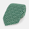 View 1 of product The Turnbull & Asser Forest Green Flower Patterned Silk Tie, crafted from fine English silk, features a repeating white floral design and is shown rolled up on a white background.