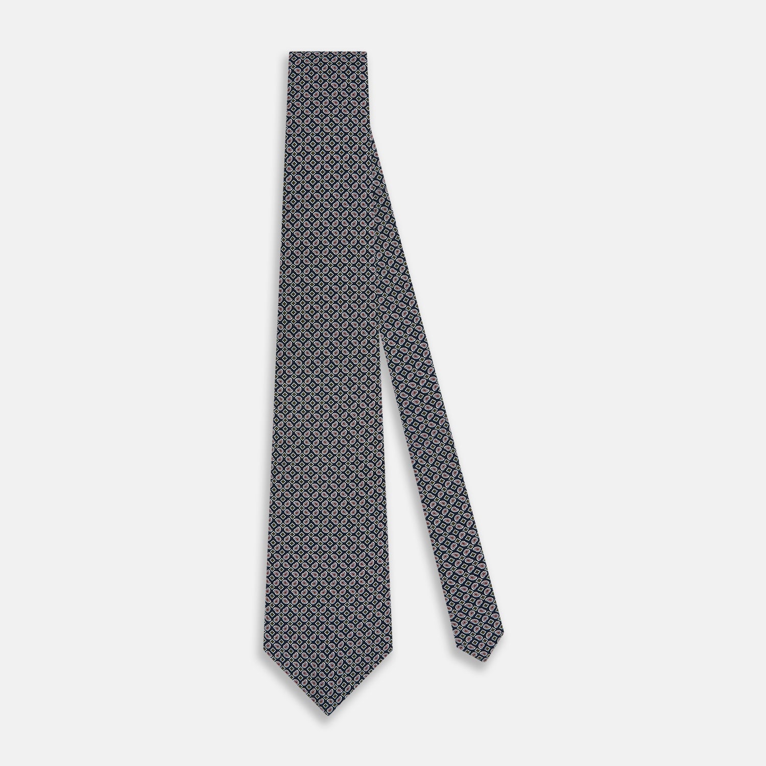 View 2 of product The Turnbull & Asser Navy Mélange Paisley and Square Print Silk Tie is crafted from fine silk, showcasing a repeating paisley and square pattern in blue tones, elegantly rolled for display on a white background.