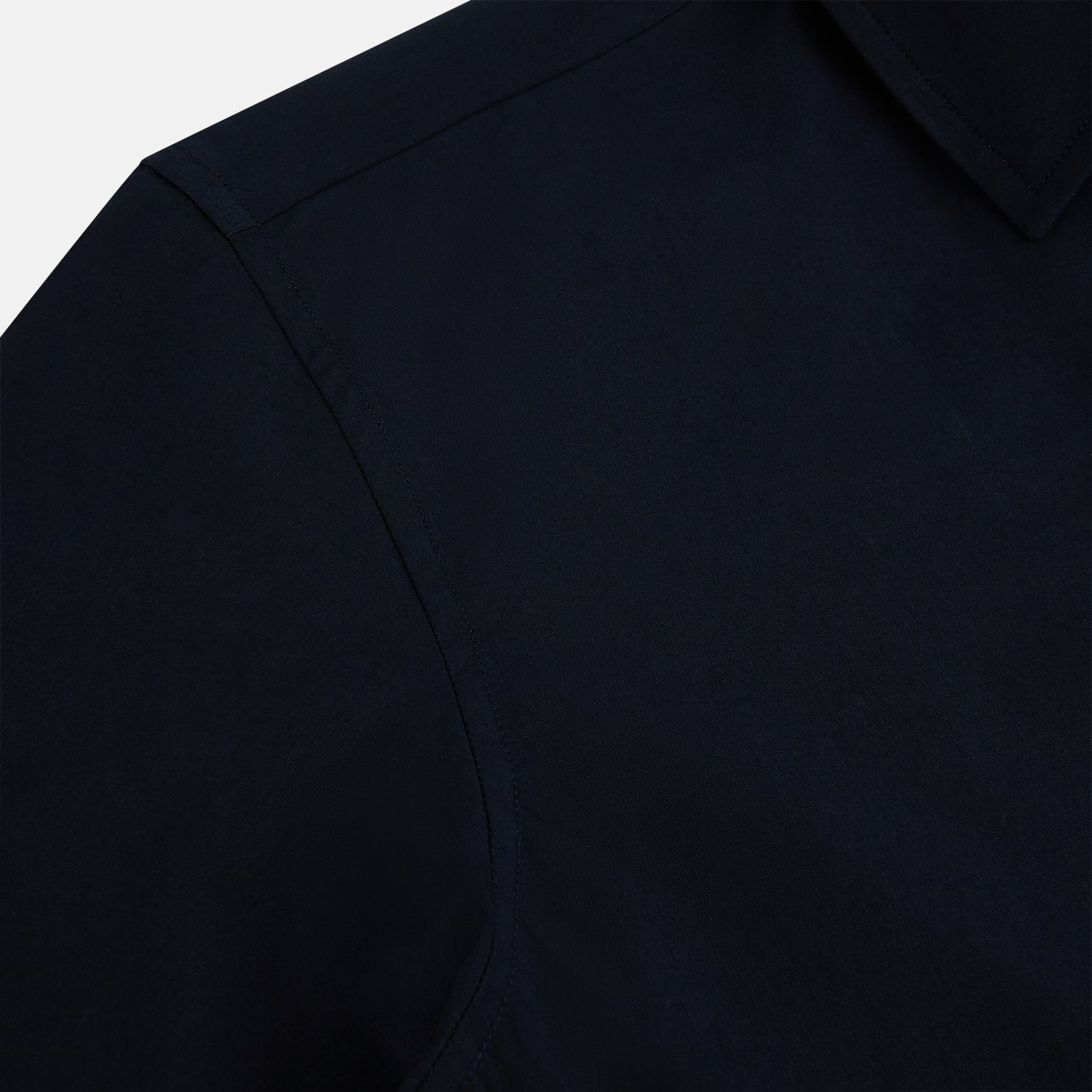 View 6 of product The NAVY BLUE WINDSOR SHIRT by Turnbull & Asser features long sleeves, a classic Windsor collar, white buttons, and buttoned cuffs—highlighting refined British craftsmanship against a plain white background.