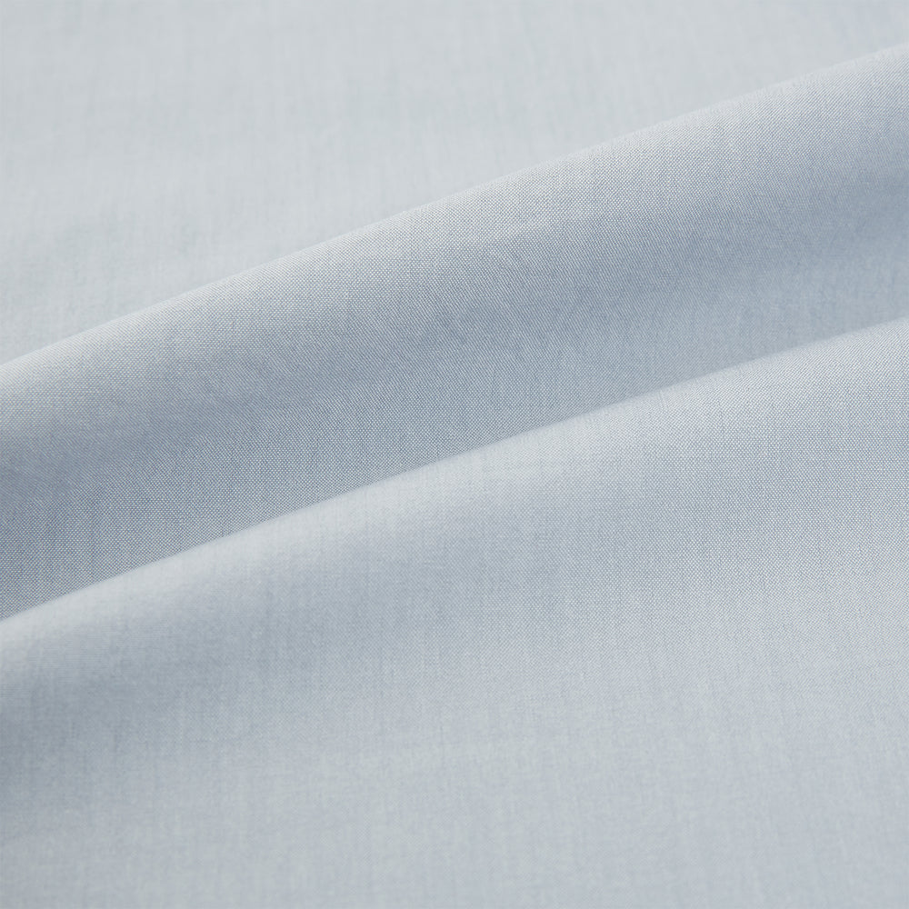 The Dove Grey Mayfair Shirt by Turnbull & Asser is a long-sleeve button-up with a collar, front pocket, and white buttons, crafted from soft sanforised cotton and laid flat on a white background.