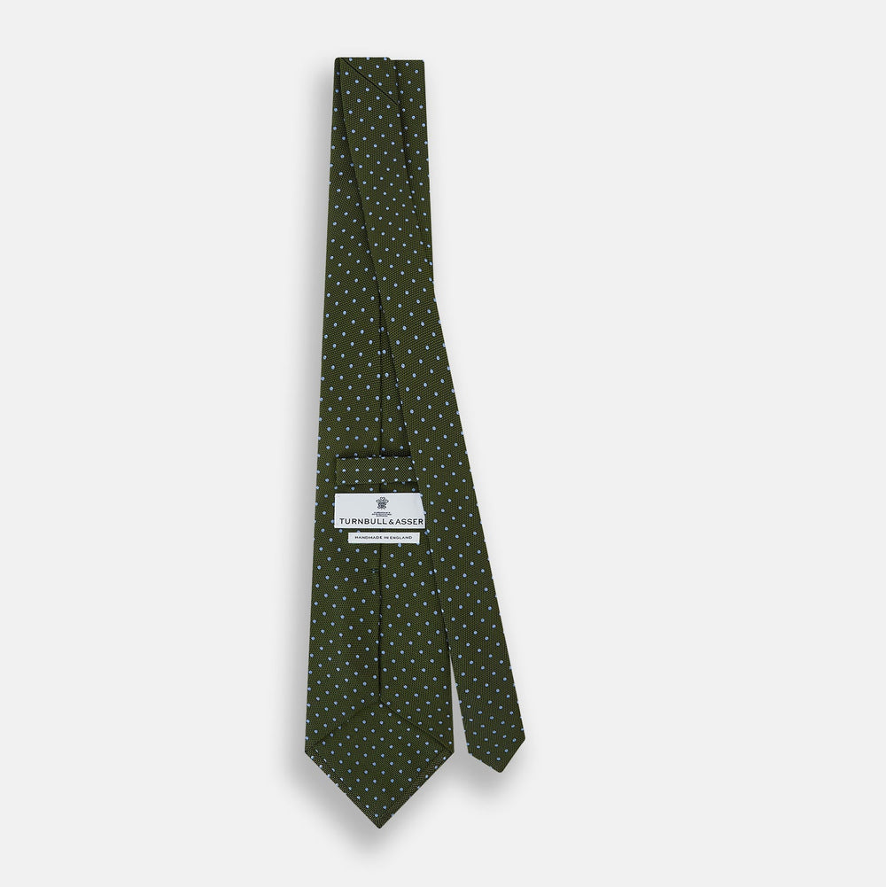 The Turnbull & Asser Green and Blue Micro Dot Silk Tie is shown rolled up, displaying small light blue dots on green silk against a plain white background.