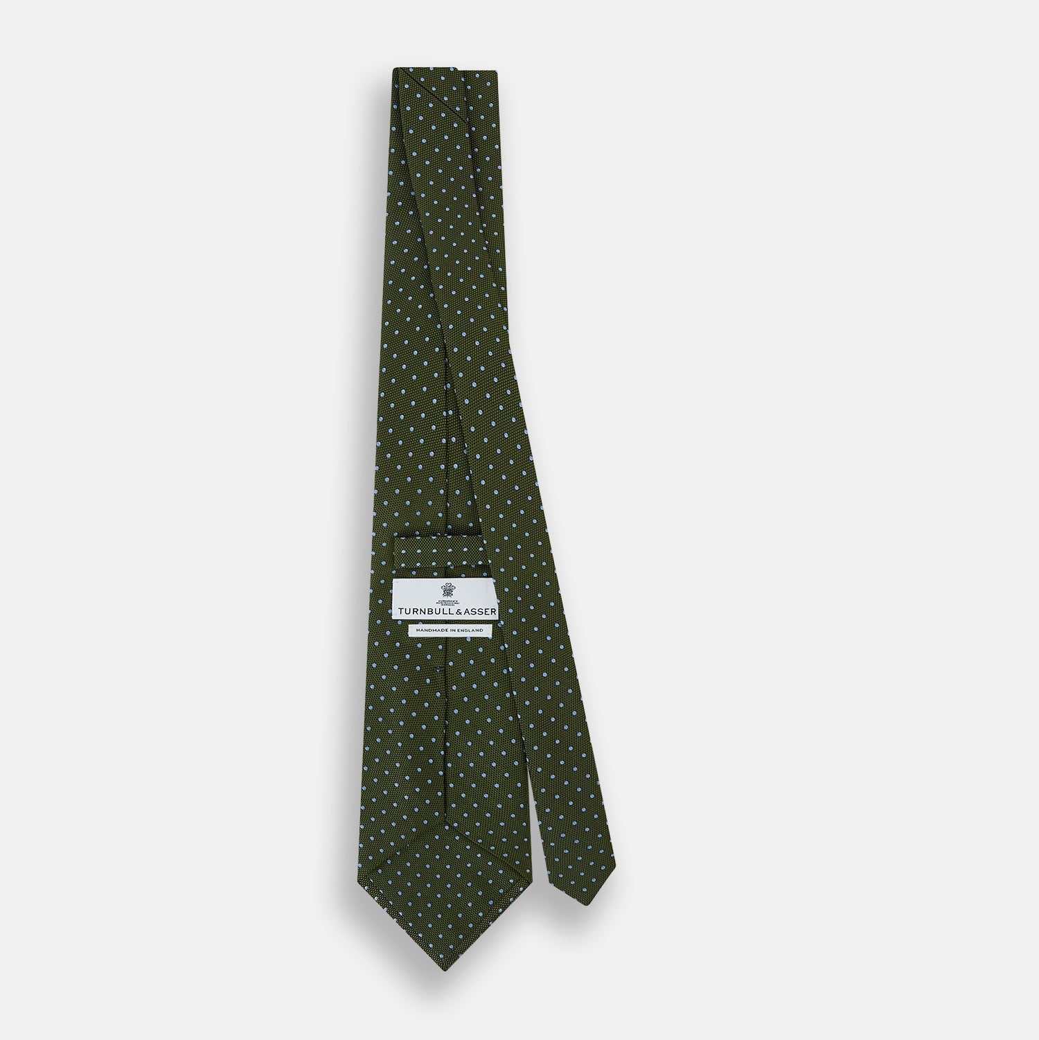 View 4 of product The Turnbull & Asser Green and Blue Micro Dot Silk Tie is shown rolled up, displaying small light blue dots on green silk against a plain white background.