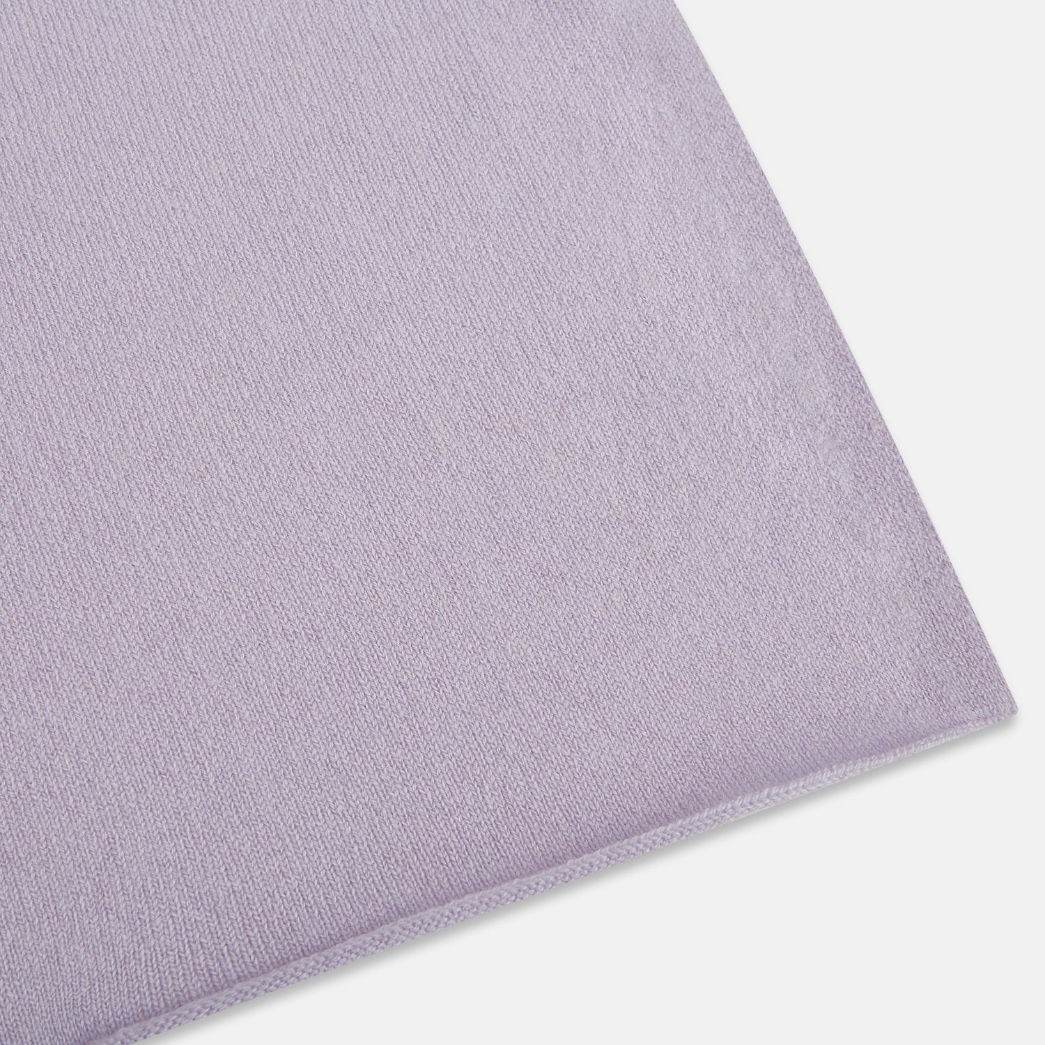 Image 2 of product The Turnbull & Asser Plain Lilac Cashmere Knitted Scarf is shown neatly tied in a loose knot against a plain white background, highlighting its elegant and timeless design.