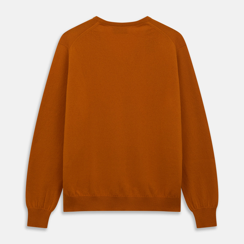 The Turnbull & Asser Rust Paden V-Neck Jumper, a pure cashmere sweater with long sleeves and ribbed cuffs and hem, is laid flat on a white background with the label visible at the neck.