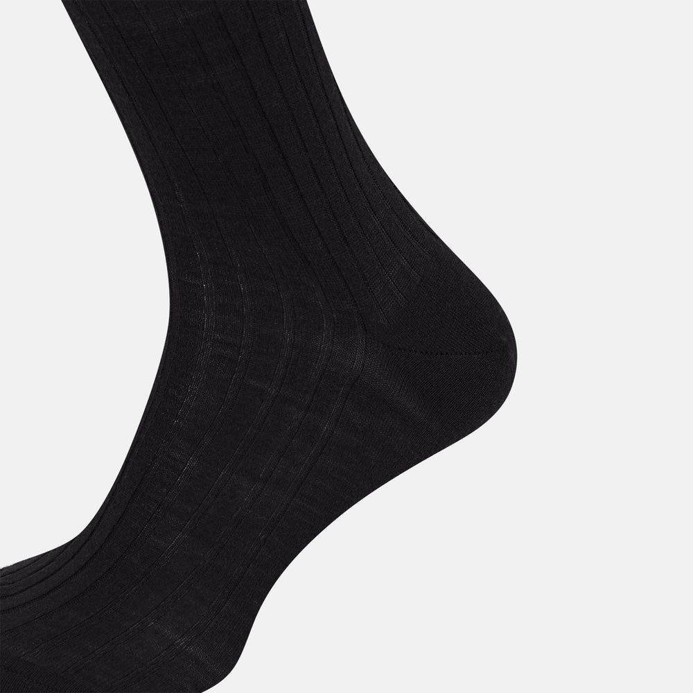 The Turnbull & Asser Black Wool Long Sock stands upright on a white background, featuring a ribbed texture with a fitted foot and calf, ideal for those seeking stylish over the calf socks.