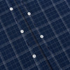 View 7 of product The Indigo and White Thin Plaid Check Windsor Shirt by Turnbull & Asser, a long-sleeve button-up with white buttons, is shown laid flat on a white background.