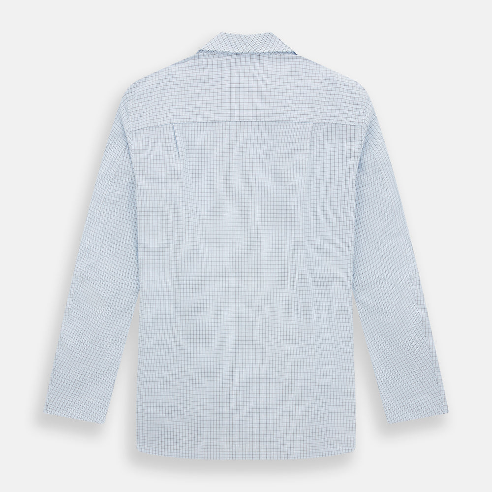 The Turnbull & Asser Blue Graph Check Pyjama Shirt features long sleeves, a collar, and a small check pattern in light blue—ideal as elegant loungewear.