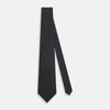 View 2 of product The Turnbull & Asser Navy and White Circle Silk Tie features a repeating circle pattern and is shown rolled on a white background—a timeless men's accessory for any occasion.
