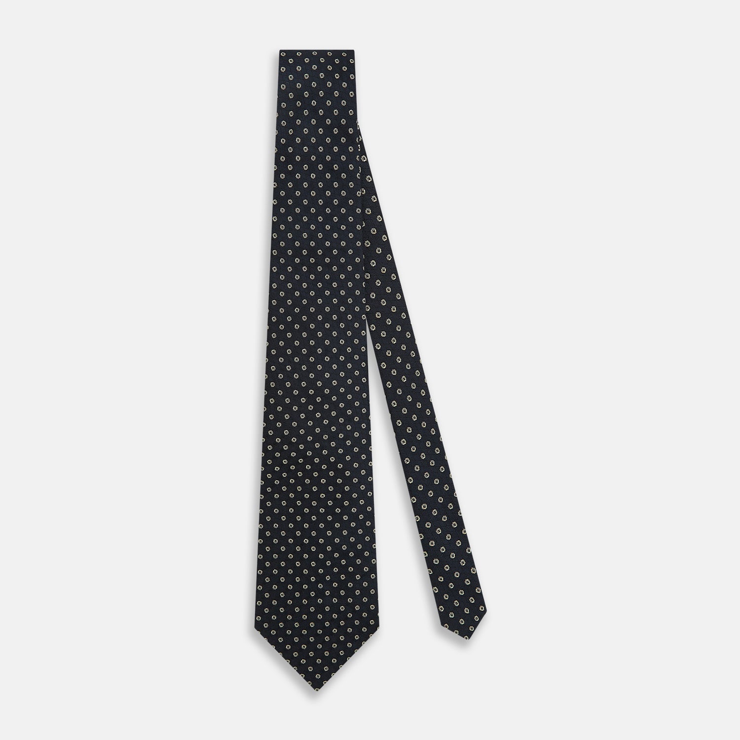 View 2 of product The Turnbull & Asser Navy and White Circle Silk Tie features a repeating circle pattern and is shown rolled on a white background—a timeless men's accessory for any occasion.