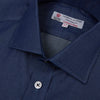 View 4 of product The Turnbull & Asser Dark Blue Denim-Cashmere Shirt features a Regent collar, long sleeves, and 3-button cuffs, neatly folded and displayed on a plain light background.