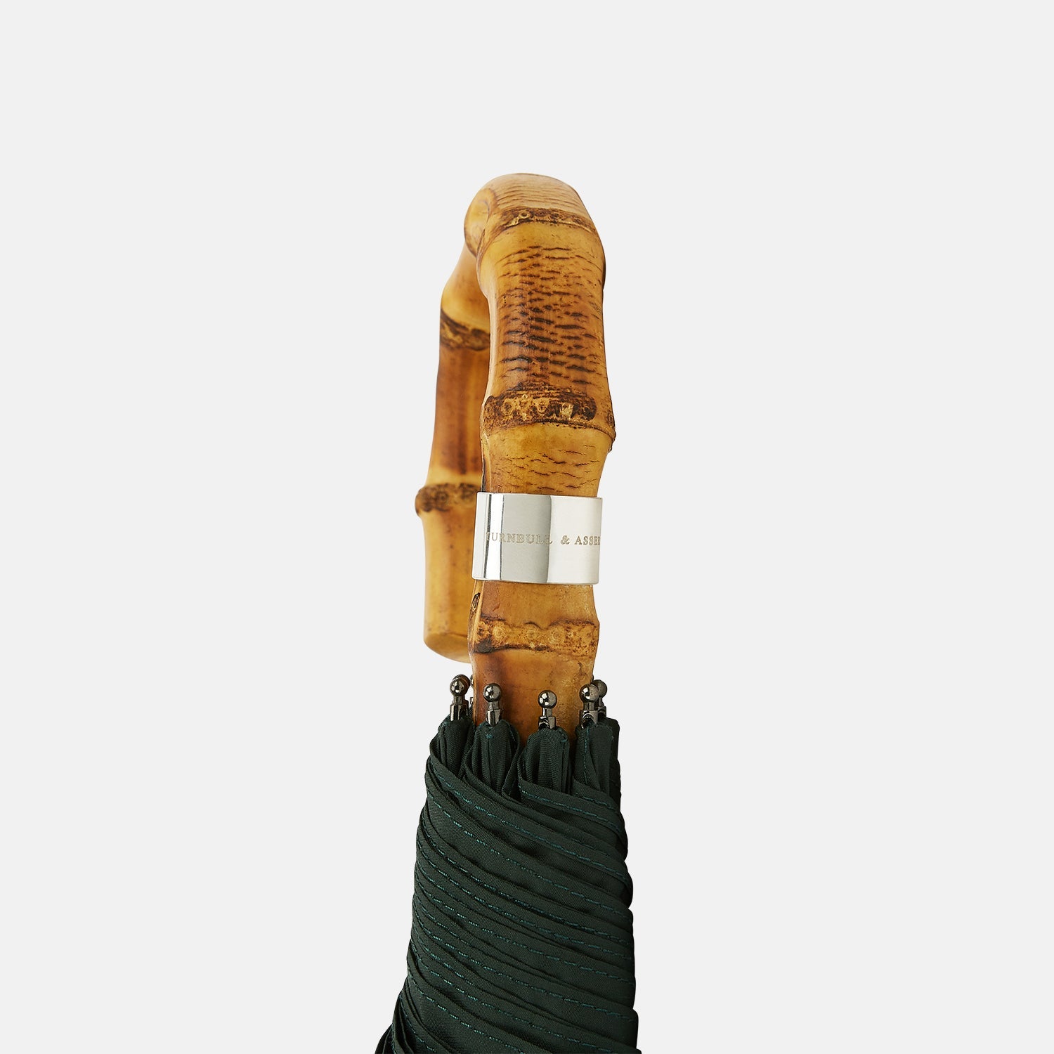 View 3 of product The Turnbull & Asser Forest Green Telescopic Umbrella with a whangee crook handle is opened and displayed on a plain white background, highlighting its expert craftsmanship and timeless style.