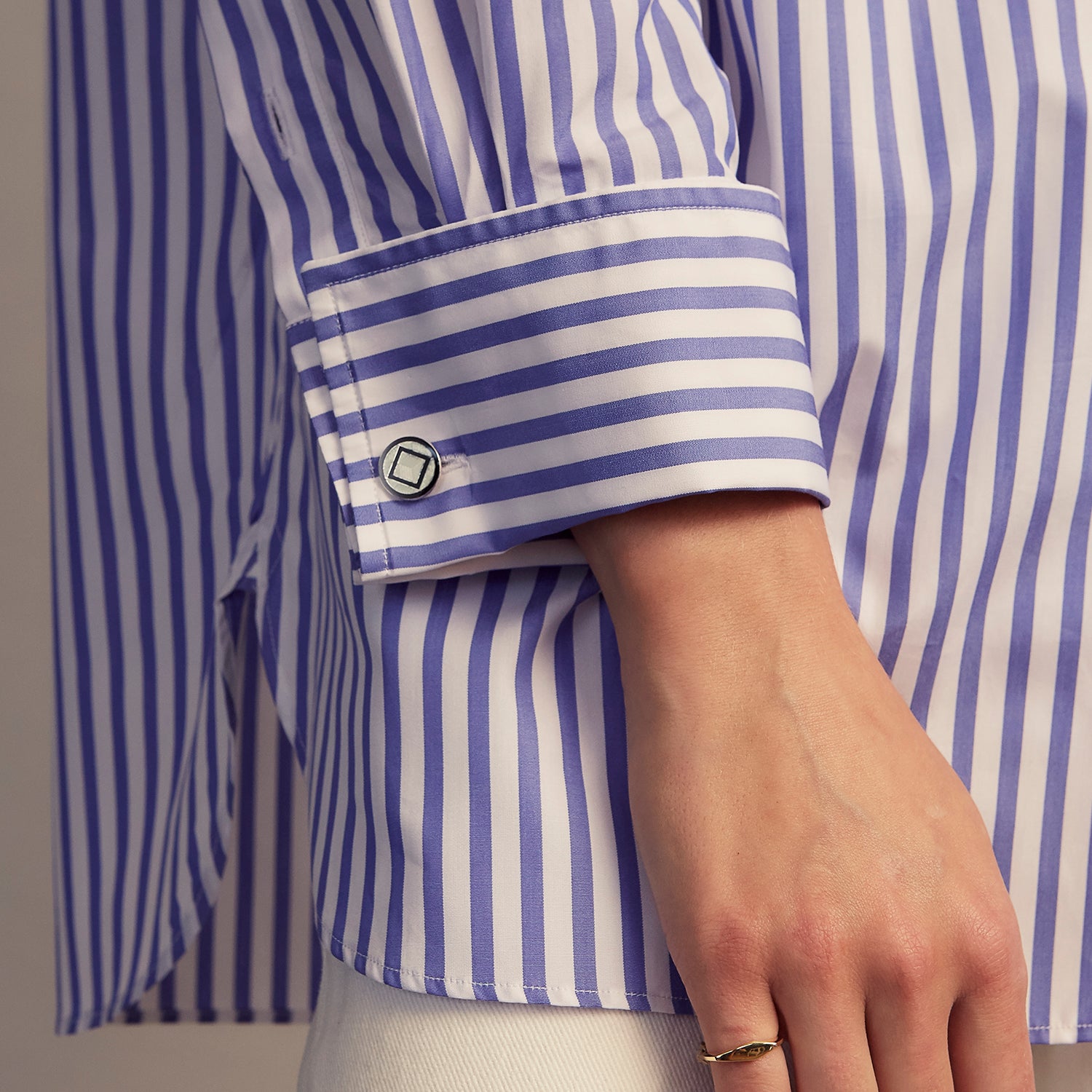 View 8 of product The Turnbull & Asser Pale Blue Candy Stripe Cotton Marlene Shirt is an oversized women's collared shirt with long sleeves, buttoned cuffs, and vertical blue and white stripes, shown laid flat on a white background.