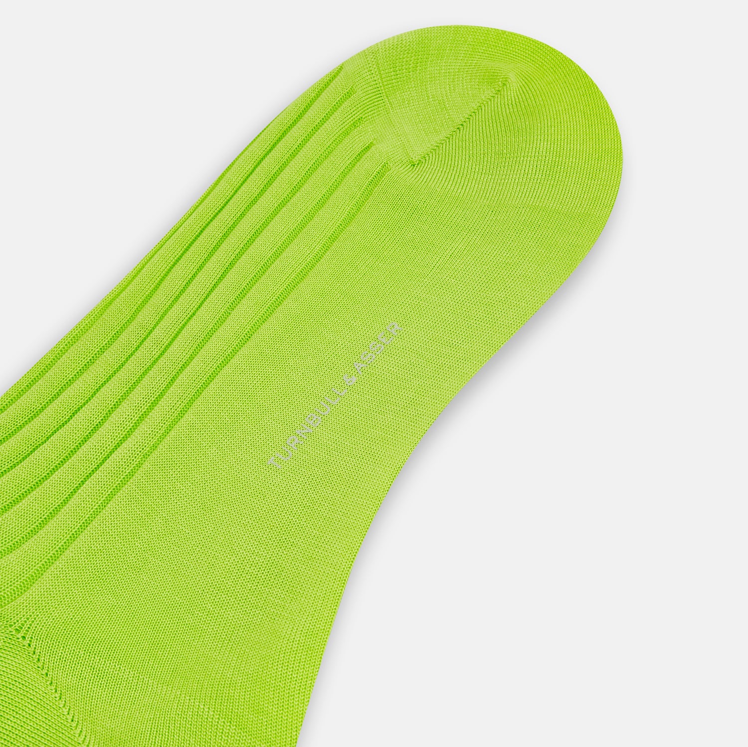 View 3 of product The Turnbull & Asser Lime Mid-Length Sock is crafted from soft mercerised cotton with a ribbed texture and shown against a plain light gray background.