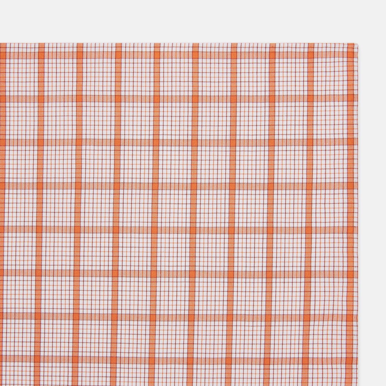 View 2 of product The Turnbull & Asser Hand Rolled Orange Graph Overlay Check Handkerchief features bold orange and white checks with blue and orange grid lines—a refined, classic accessory for any gentleman.