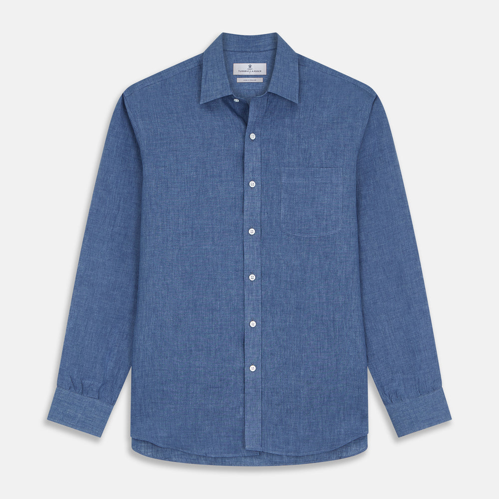 The Blue Weekend Fit Linen Finch Shirt by Turnbull & Asser features a Derby collar, chest pocket, and white buttons. Made from mid-blue linen chambray, it offers effortless casual style when laid flat on a plain white background.
