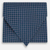 View 1 of product The Turnbull & Asser Navy and Red Rosette Cravat is adorned with a repeating geometric pattern of red, white, and light blue circles—an ideal formal accessory displayed against a white background.