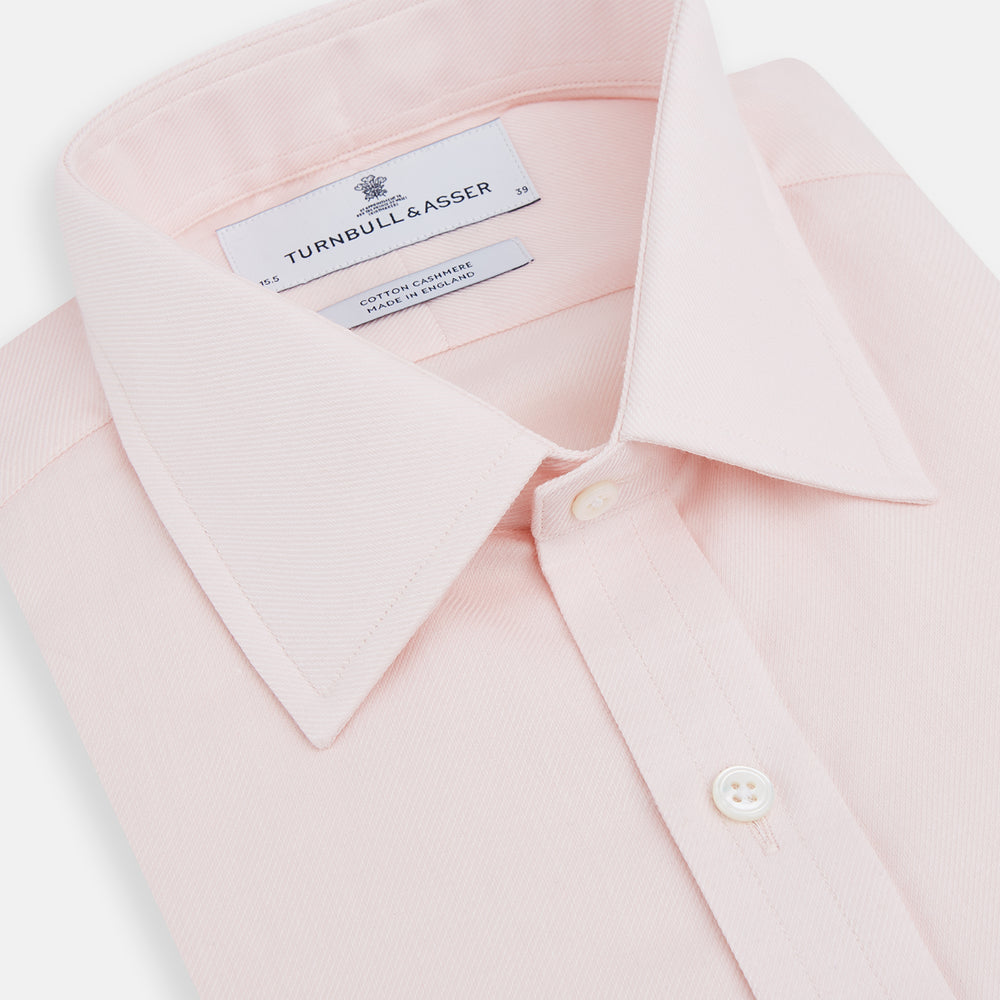 The Pale Pink Cotton Cashmere Mayfair Shirt by Turnbull & Asser features a classic collar, button-down front, and buttoned cuffs, crafted from a luxurious cotton-cashmere blend and displayed flat on a white background.