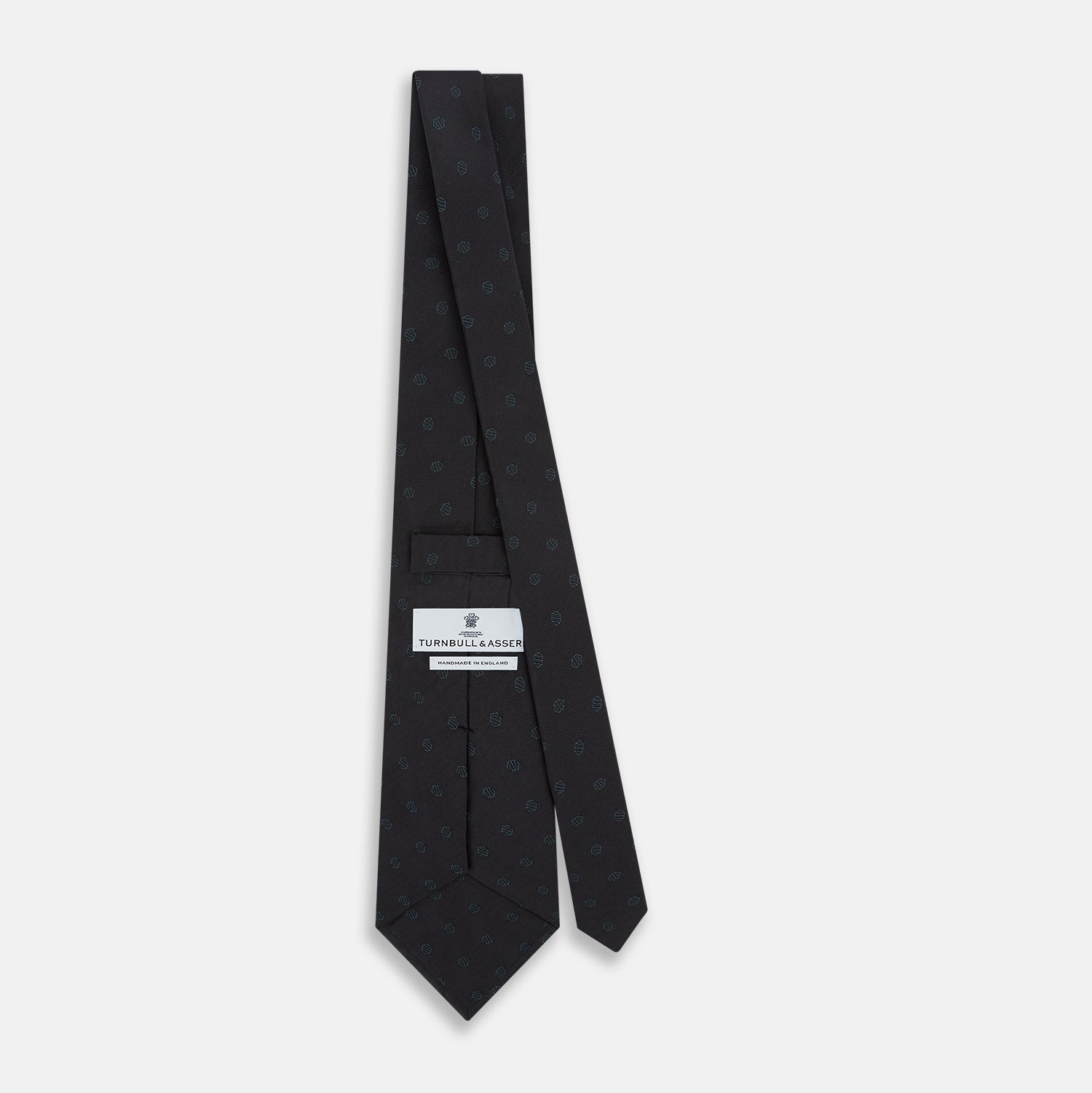 View 4 of product The Turnbull & Asser Teal and Navy Circle Silk Tie features a subtle herringbone pattern with small repeating circle motifs, displayed neatly rolled on a white background.
