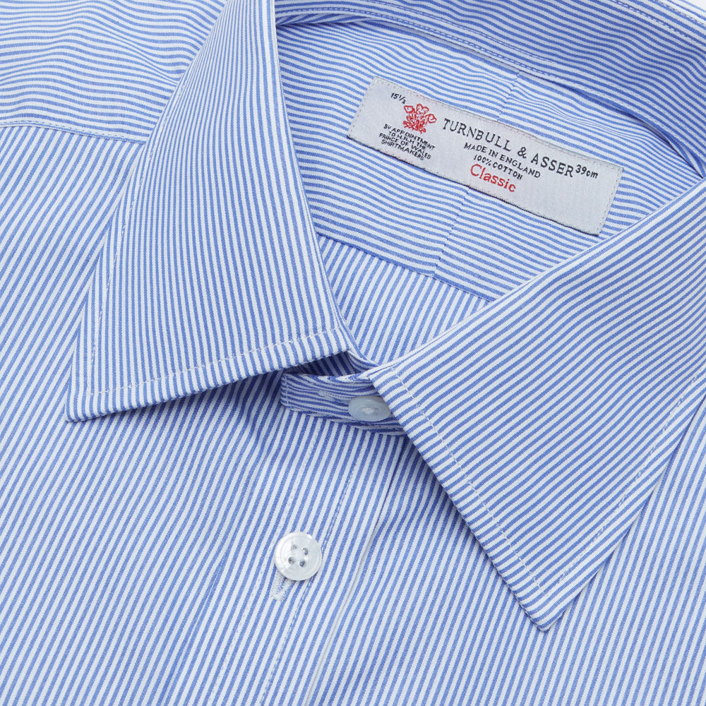 The Turnbull & Asser Blue Fine Bengal Stripe Shirt features a classic T&A collar, 3-button cuffs, and white buttons, crafted from fine cotton and displayed against a crisp white background.