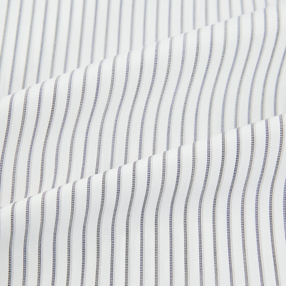 The Navy Music Stripe Mayfair Shirt by Turnbull & Asser features thin vertical blue and white stripes, a classic T&A collar, and long sleeves, shown on a plain white background.