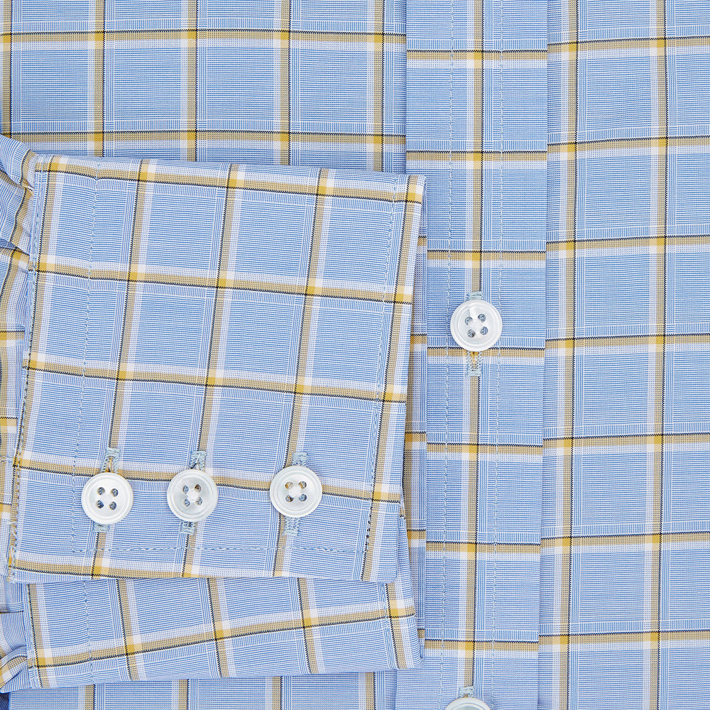 The Turnbull & Asser Blue and Yellow Windowpane Mayfair Shirt is crafted from fine Italian cotton, featuring a light blue base with yellow and white checks, shown on a plain white background.