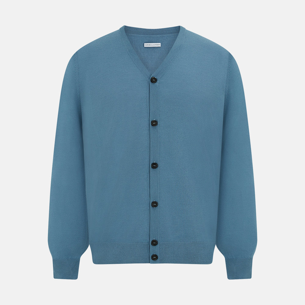 The Turnbull & Asser Pale Blue Fine Merino V-Neck Cardigan features long sleeves and five black buttons, showcased on a plain white background.