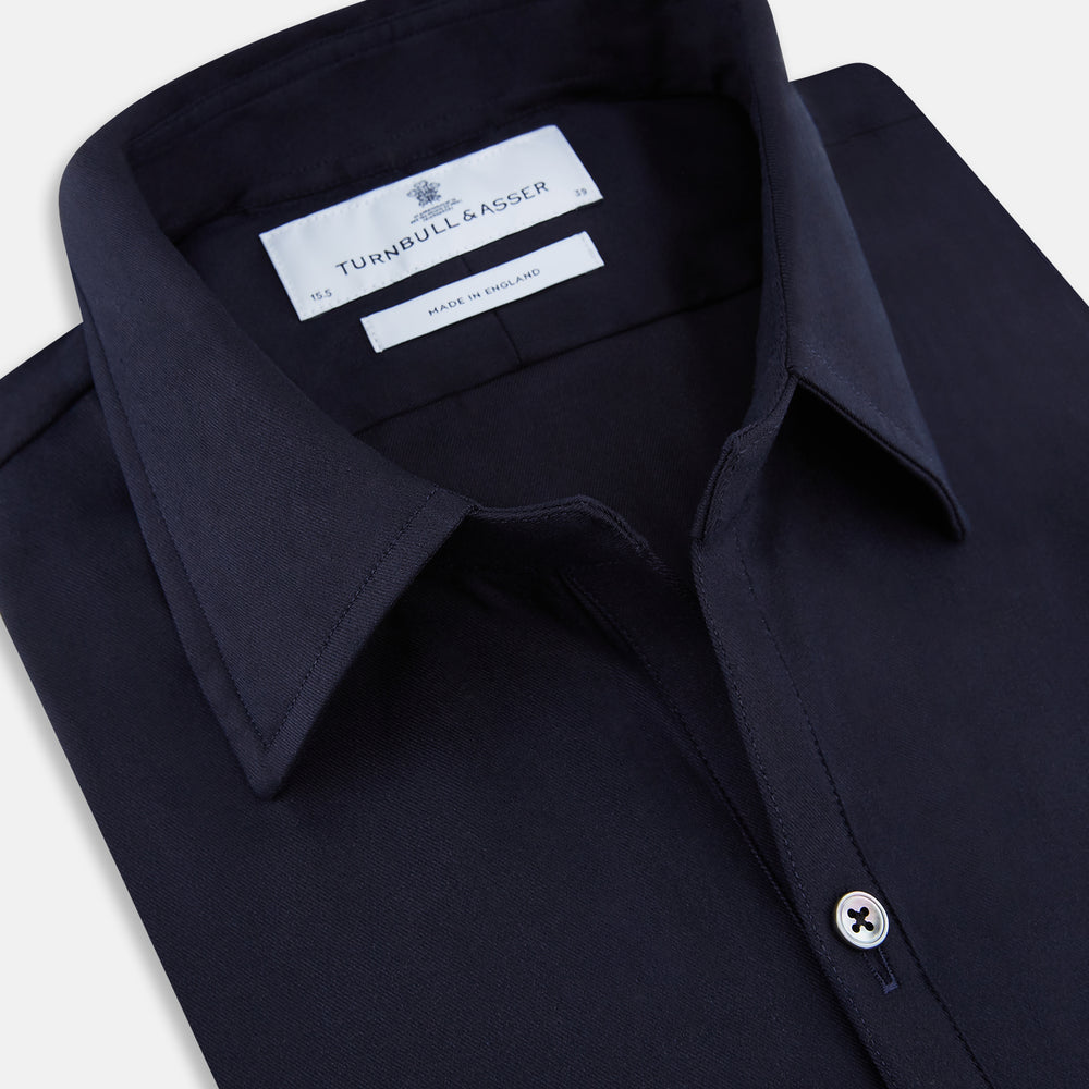 The Navy Twill Windsor Shirt by Turnbull & Asser features long sleeves, a button-up front, British craftsmanship, and a refined Windsor collar, shown in dark navy on a plain white background.