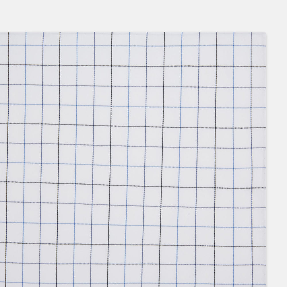 The Turnbull & Asser Hand Rolled Blue Grid Check Handkerchief features a classic blue and black grid on white cotton, neatly folded—a timeless gentleman's accessory.