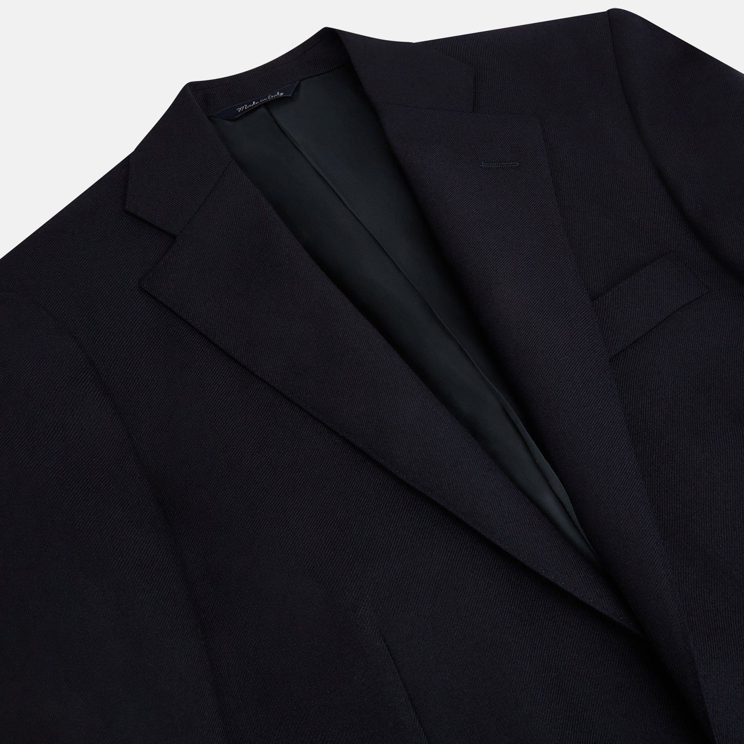 View 2 of product The Turnbull & Asser Long Navy Single Breasted Classic Blazer features British tailoring with two gold buttons, notched lapels, and three front pockets, shown on a plain white background.