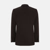 View 3 of product The Turnbull & Asser Dark Chocolate Knitted Cambridge Blazer for men, made from fine Italian wool with British tailoring, features a notched lapel, three front buttons, and three patch pockets, shown on a plain white background.