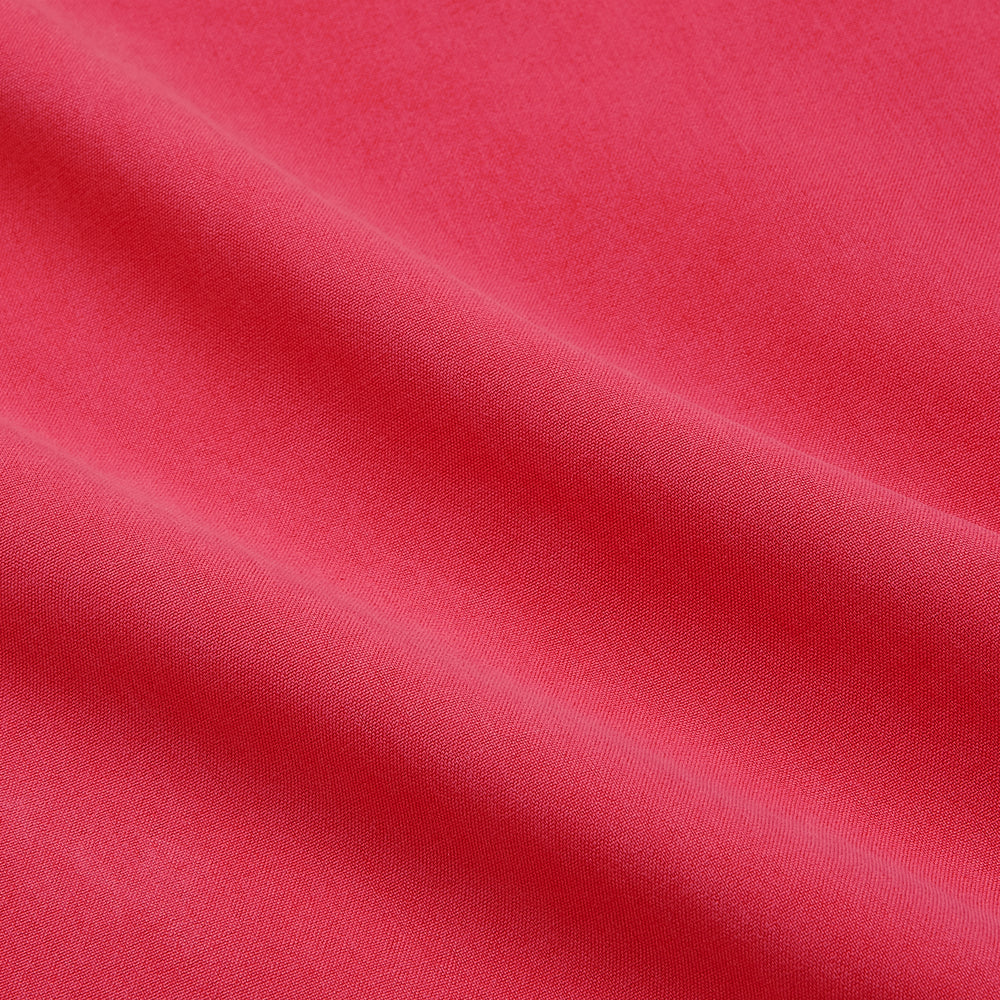 The Turnbull & Asser Coral Pink Silk Regular Fit Mayfair Shirt features long sleeves, a classic collar, and white buttons, displayed laid flat on a plain white background.