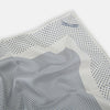 View 2 of product The Turnbull & Asser Cream Dot Silk Pocket Square features a neatly folded pure silk design with a border and center pattern of small navy blue polka dots, displayed on a plain white background.